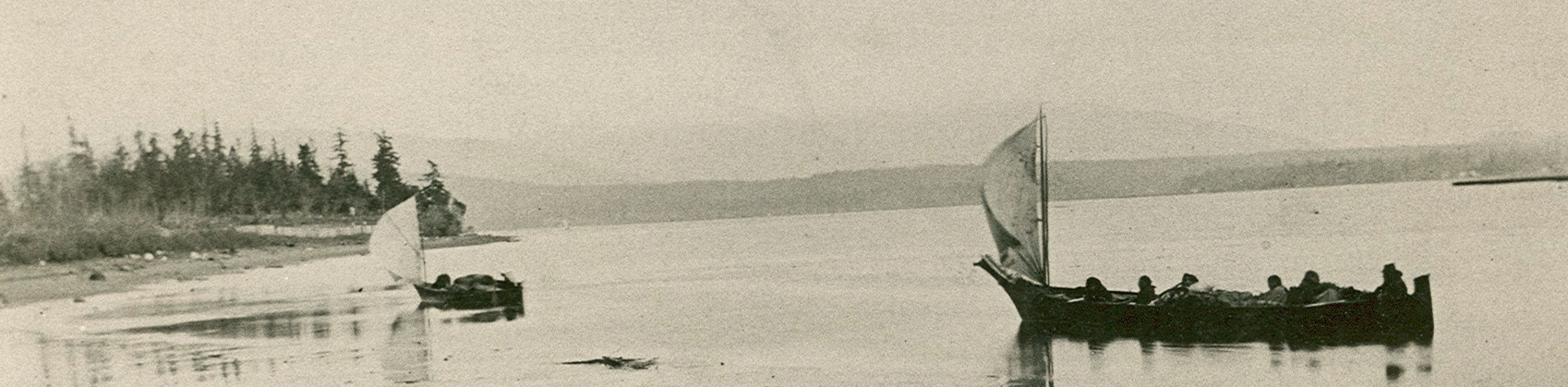 A historical photograph of sailing canoes in Fidalgo Bay.
