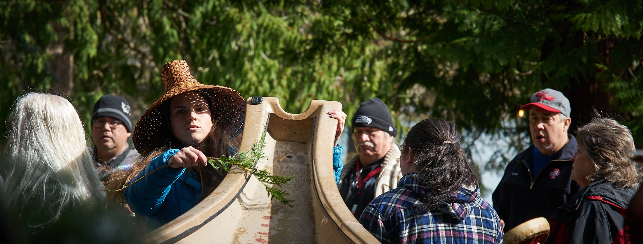 Kelly Hall brushes a Samish canoe with cedar during an annual ceremony to waken the canoes after winter.